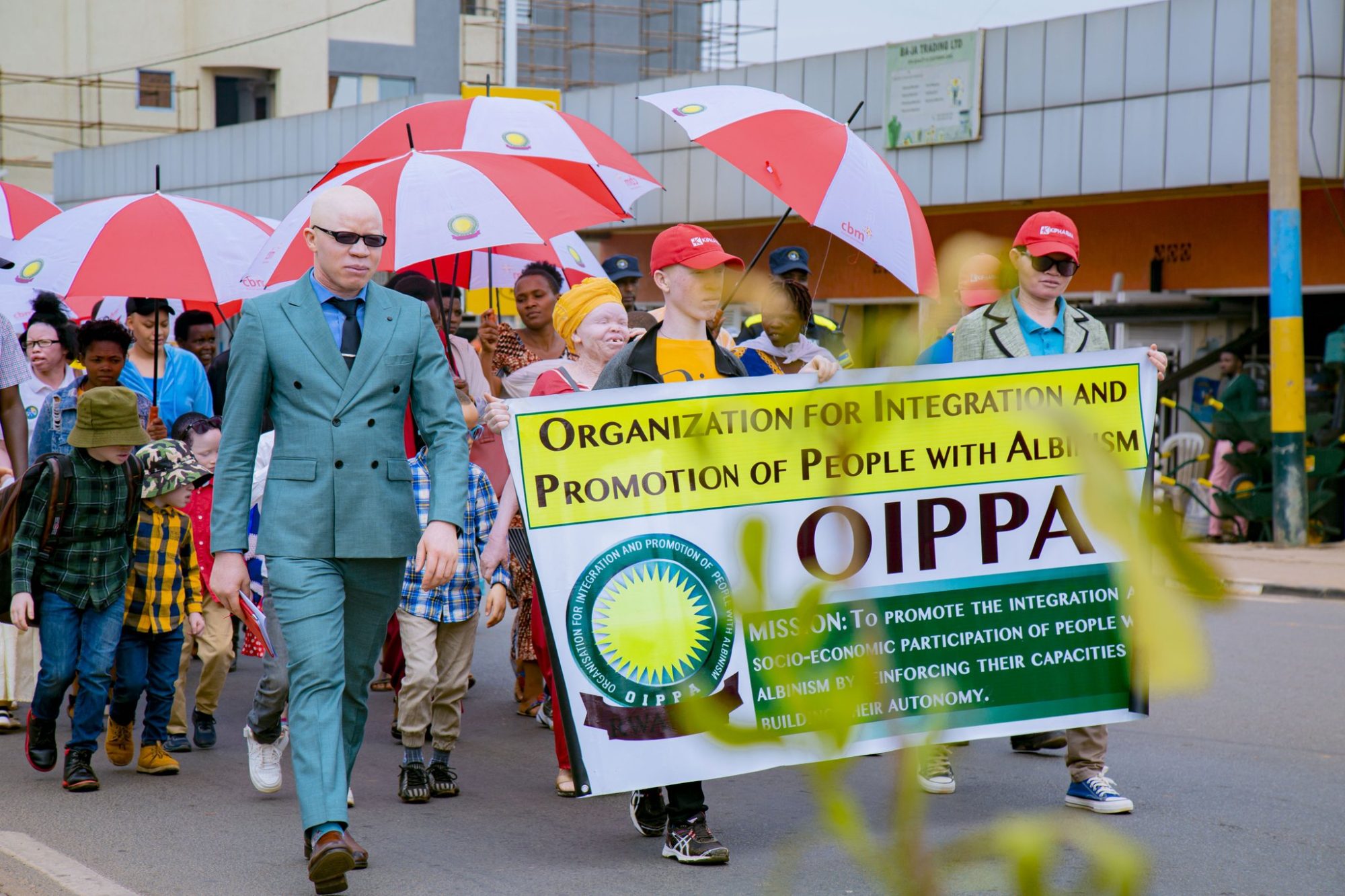 OIPPA members—persons with albinism and others— marching in Kigali with a banner.