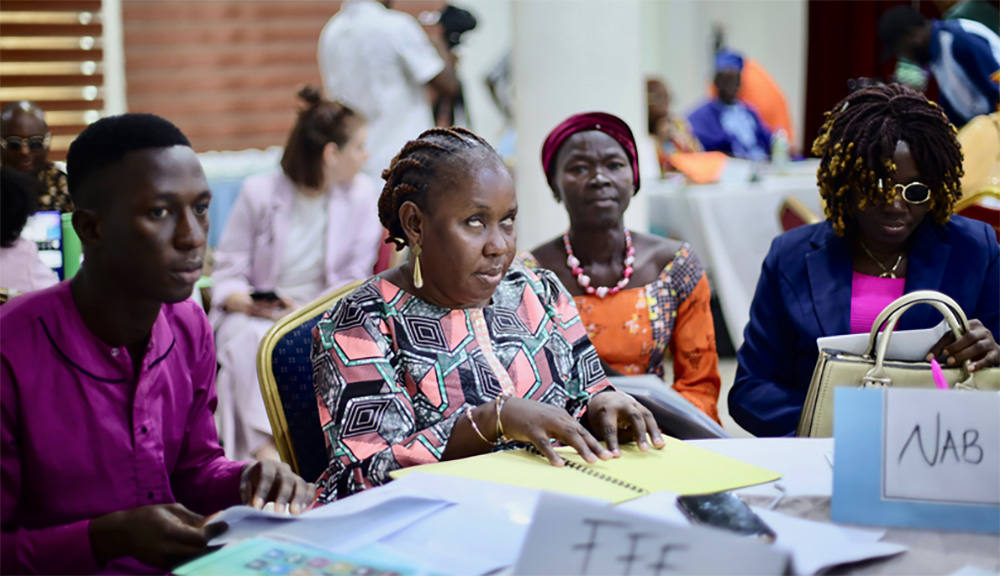 Photo of Nigerian grantees at DRF's and JONAPWD's grantee convening in Abuja. Participants are sitting around a table.