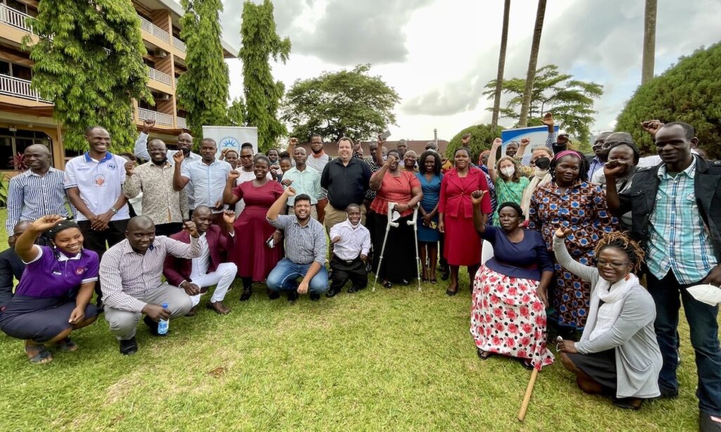 Photo of Ugandan OPDs and DRF staff and donors outdoors on a lawn in Kampala.