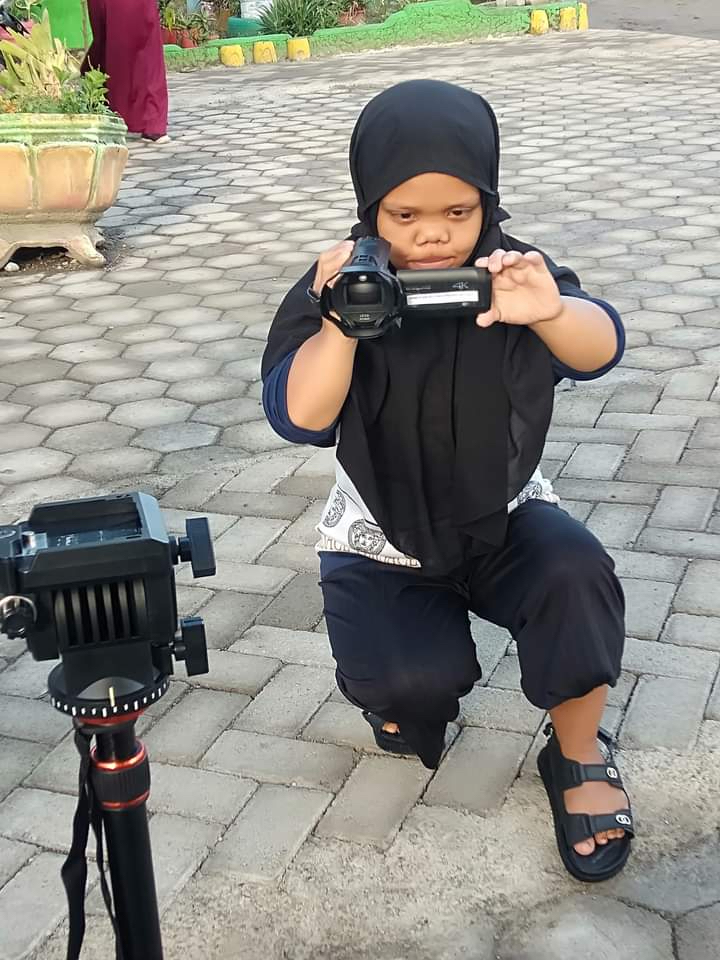 Dija films on a camcorder.