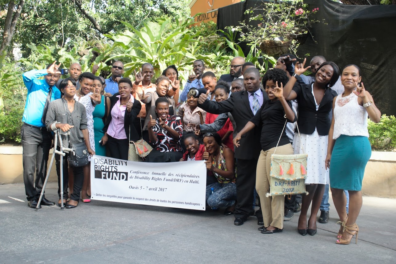 Group standing holding DRF banner