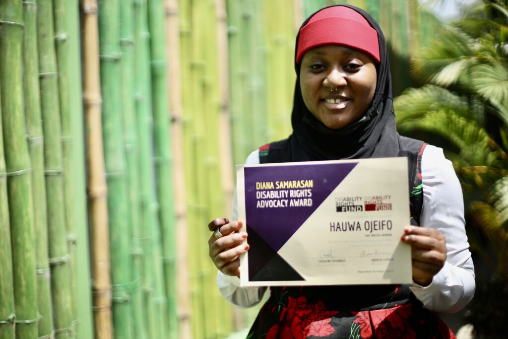 Hauwa Ojeifo poses with her award certificate in Abuja