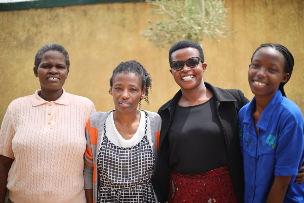 Four team members of UNABU smile for the camera in Kigali.